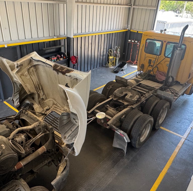 trucks to repair inside precision fleet garage