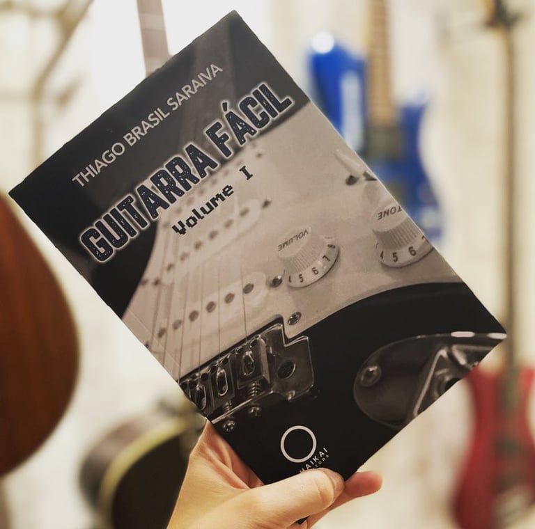 a person holding a guitar in their hand