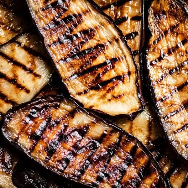 Close-up of juicy grilled eggplant slices with grill marks