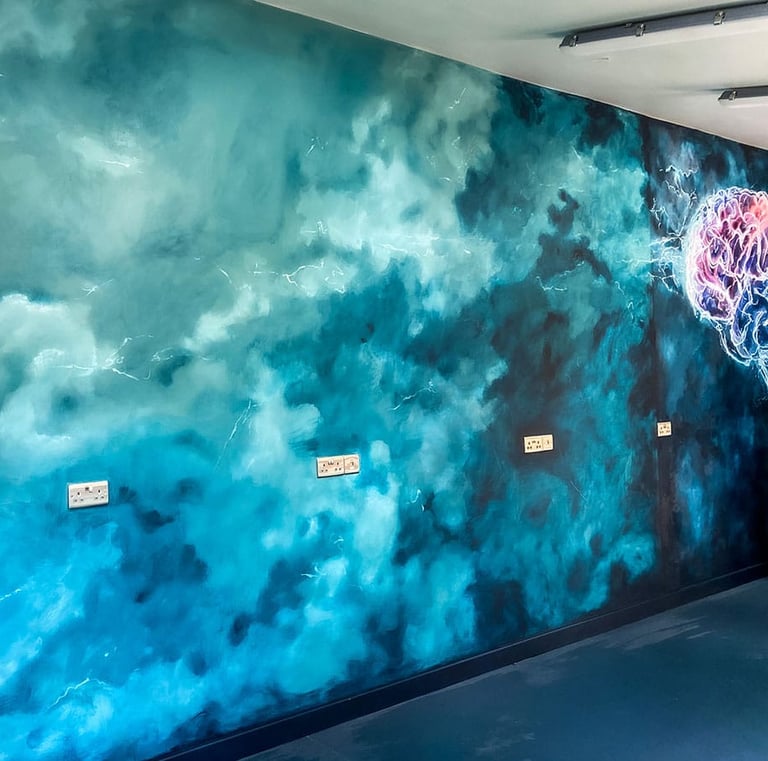 Angled view on mural with teal stormy clouds and a bit of stylised brain in pink and teal colours. 