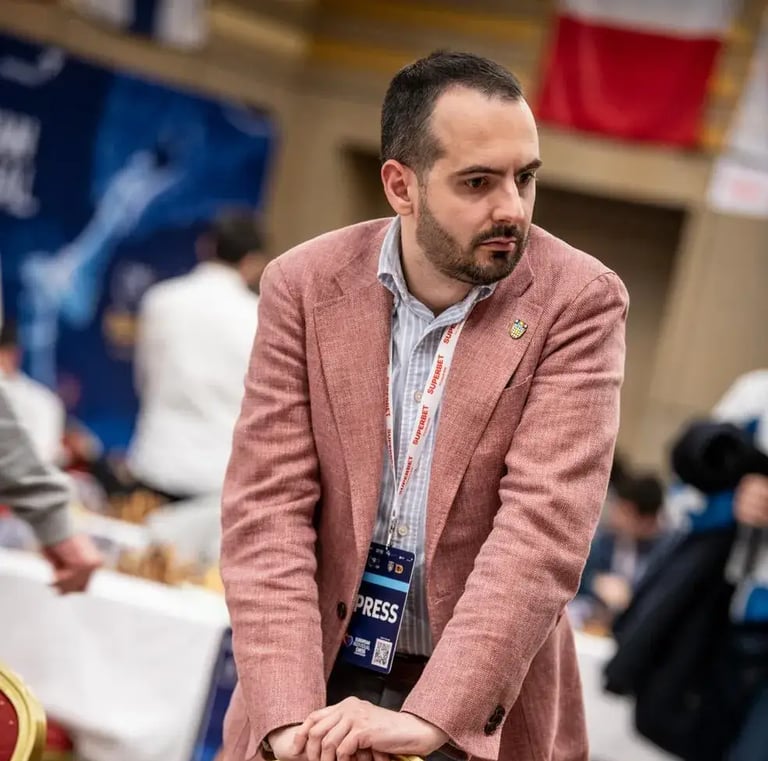 Chess journalist Vlad Ghita watching a game closely at the European Championship 2025 in Eforie Nord