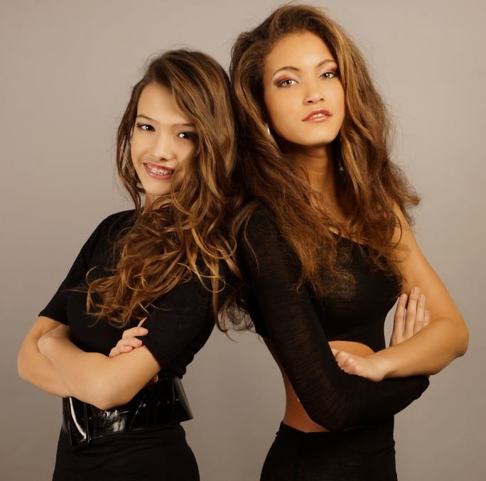 two women in black dresses posing for a professional photoshooting