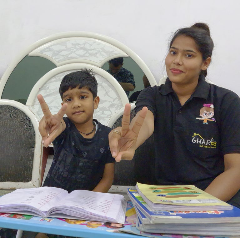 a woman sitting at a table with a child
