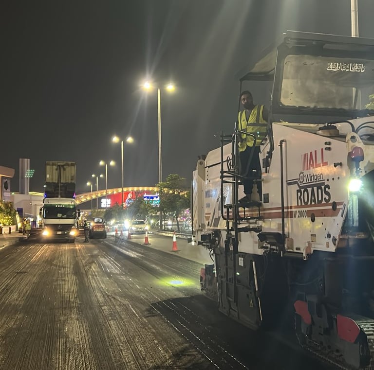 a man standing on a street with a truck behind him