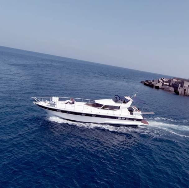 a boat in the water with a lighthouse in the background