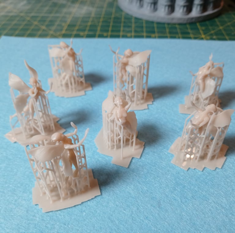 Fine detail resin fairy figures 3D printed with support structures as part of custom 3D sculptural services