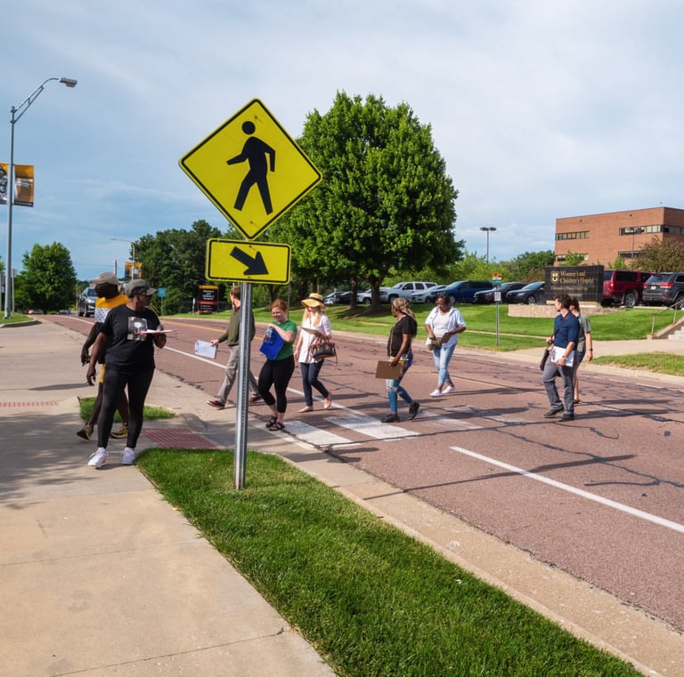 Group of people walking across a crosswalk