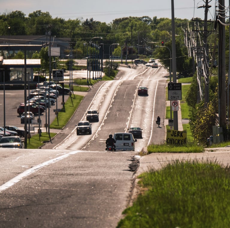 Cars on a busy road, and you can see fumes on the street