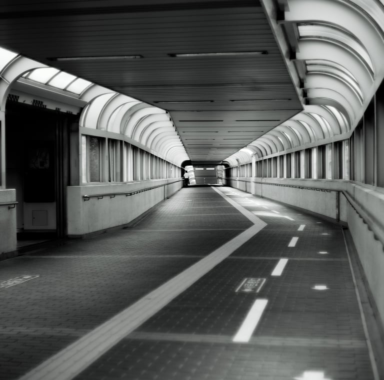 a long hallway with a long walkway and a long hallway