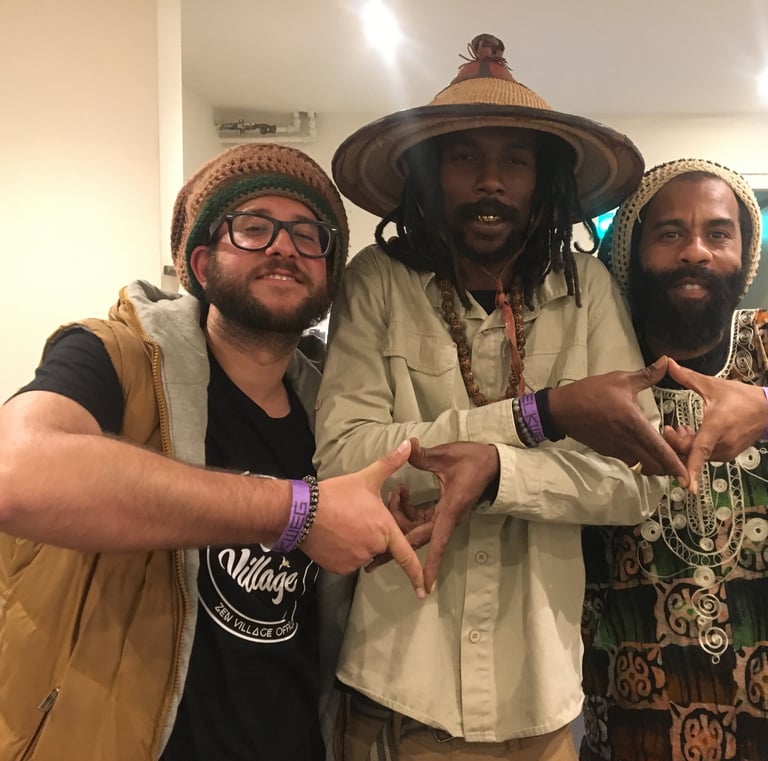 three men standing next to each other in a room
