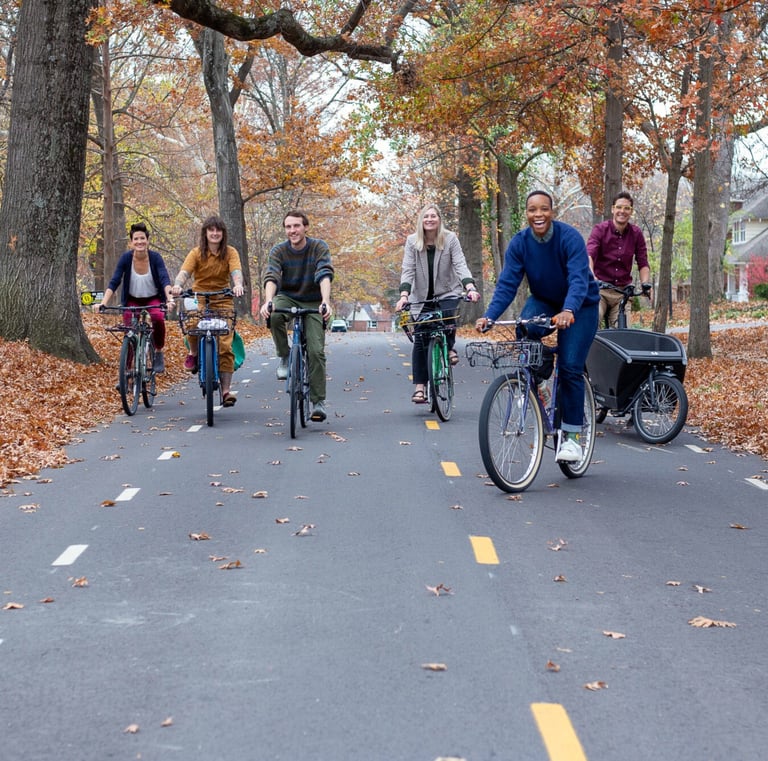 A bunch of people on bikes riding toward the camera on a bike boulevard