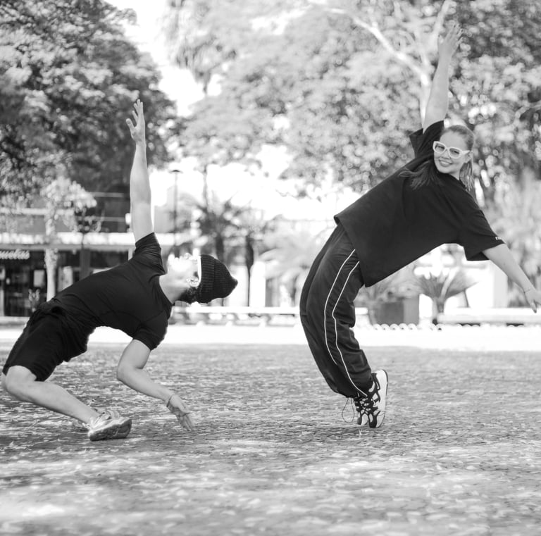 a man and a woman playing baseball in a park