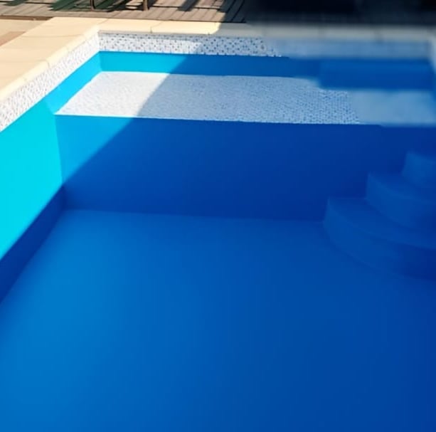 a pool with a blue pool and a pink ball