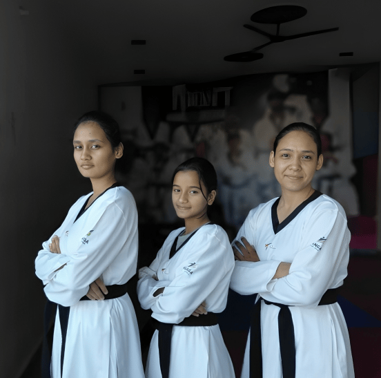 three women in white uniforms standing in a hallway