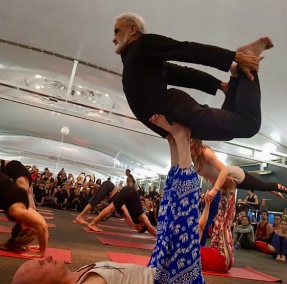 a man in a yoga pose balancing on another mans up stretched legs