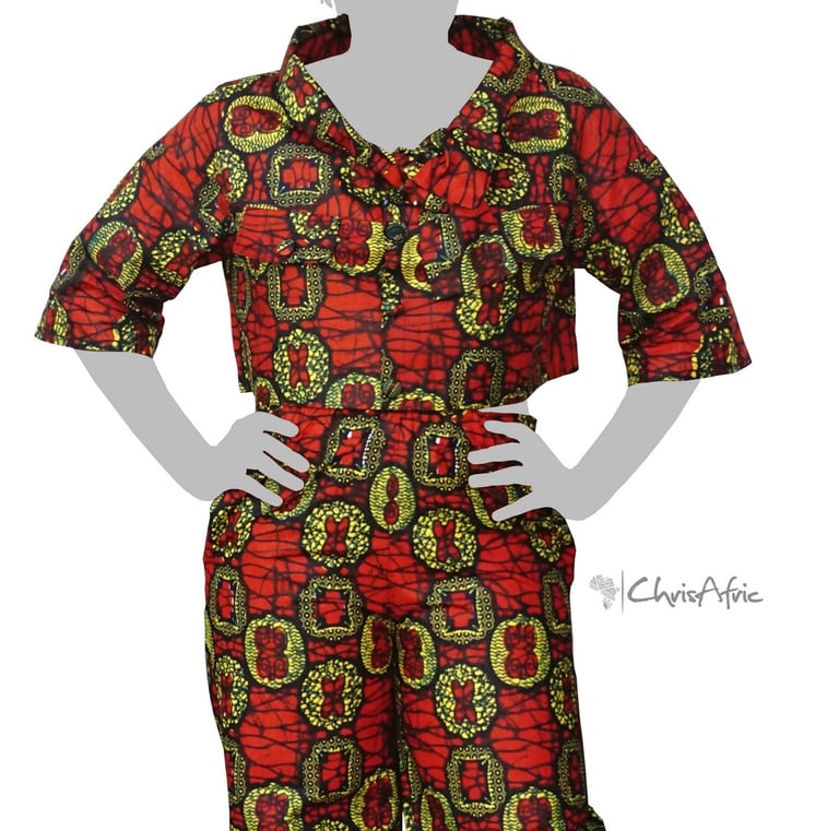 a woman in a red and green patterned blouse and pants
