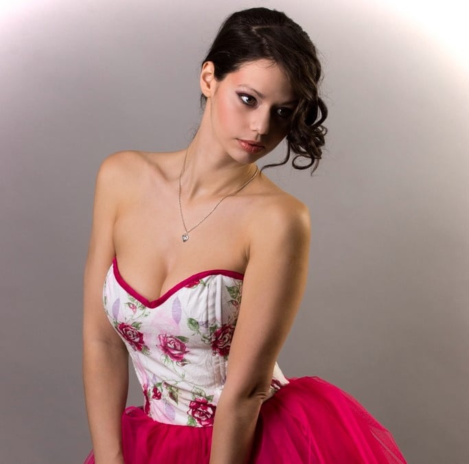 a beautiful woman in a red, white and pink special dress