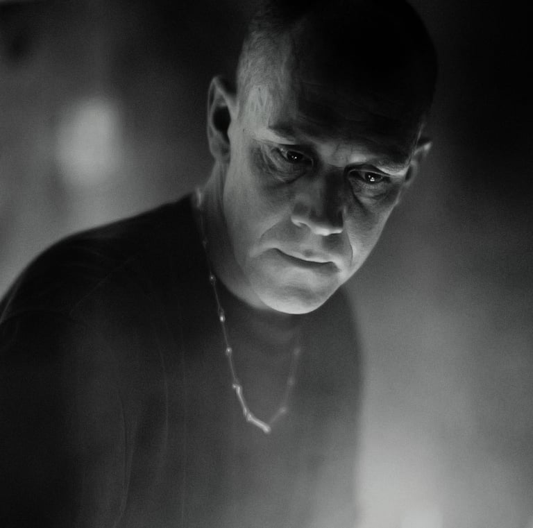a man in a black shirt and a clock