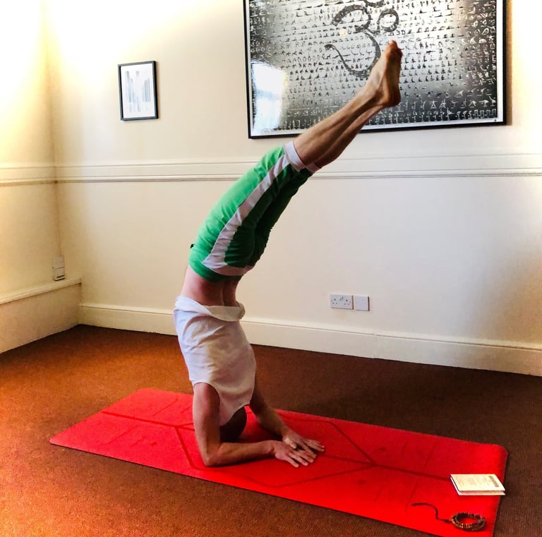 a man doing an elbow balance yoga pose