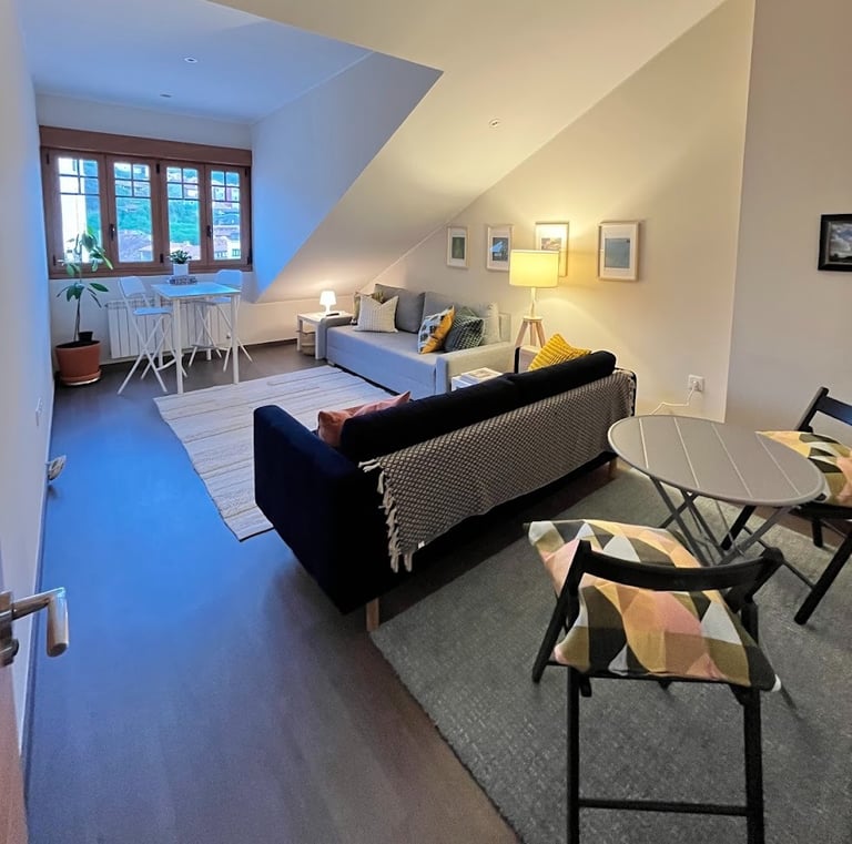 Livingroom with sleep sofas, space for dining, working and relaxing. View of the town church.