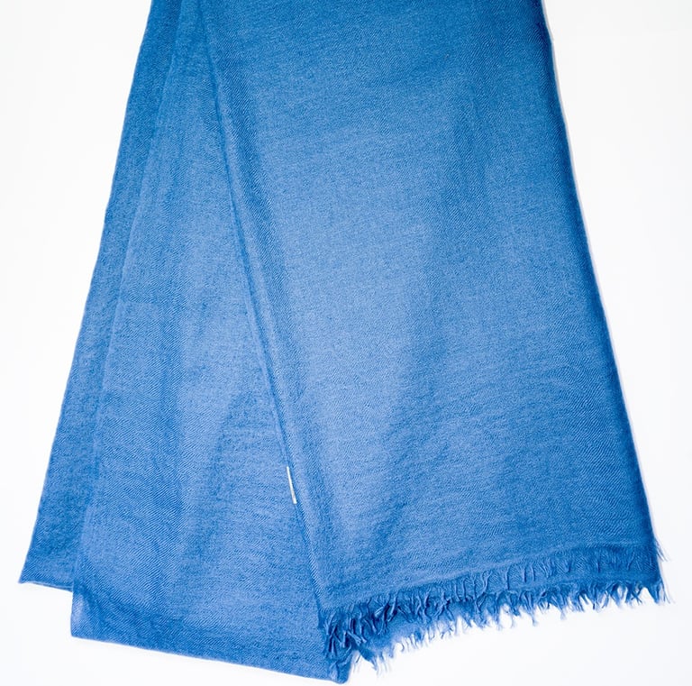 Elegant pure pashmina shawl in deep blue with soft fringes, perfect for timeless luxury style.
