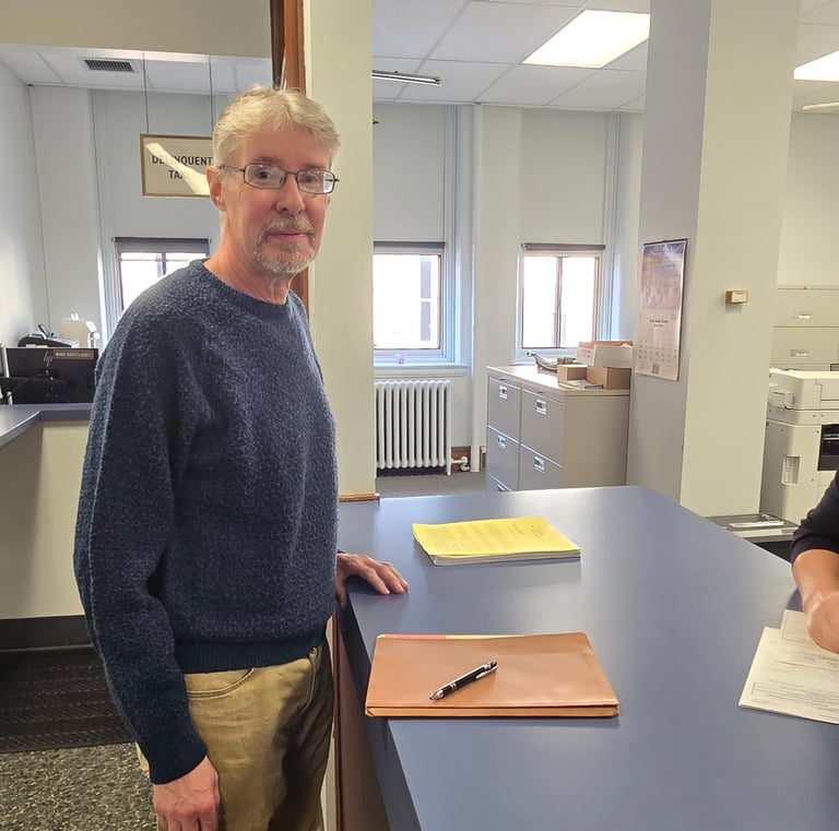 Steven Rugh getting his petition checked in at the County Office