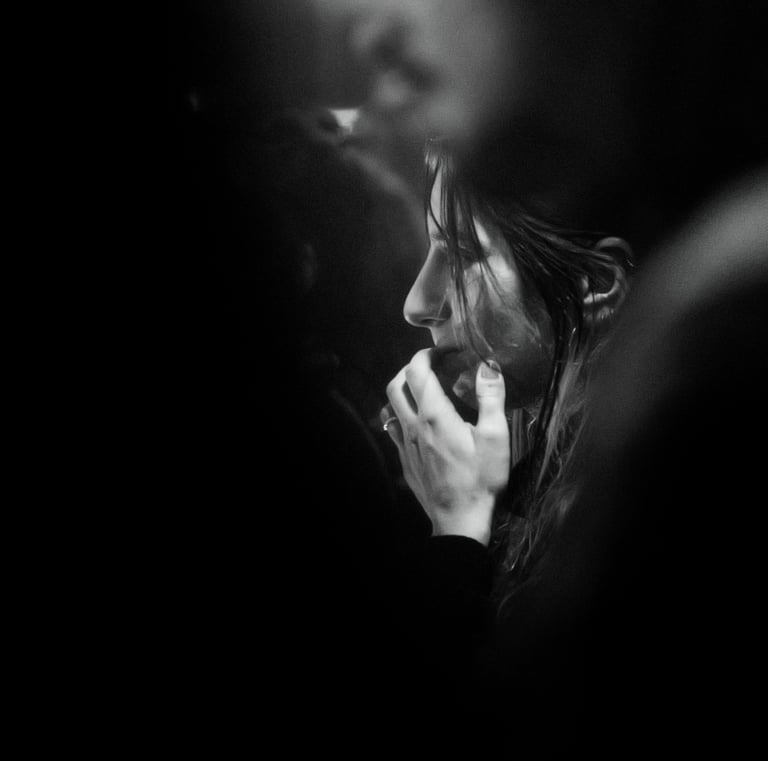 a woman talking on her cell phone while she is holding a cell phone