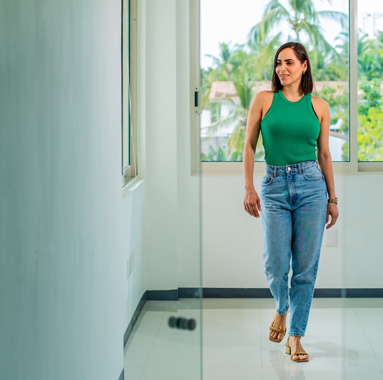a woman in a green tank top and jeans jeans