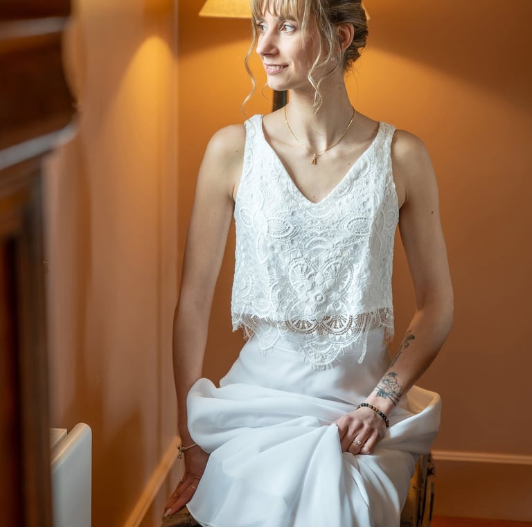 a woman in a white dress sitting on a chair