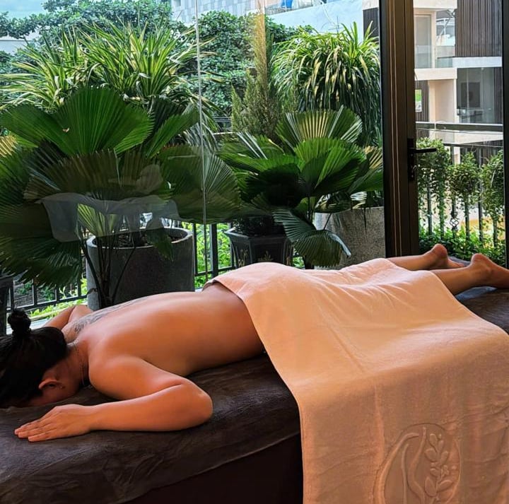 a woman is laying on a bed in a room with a view of a balcony