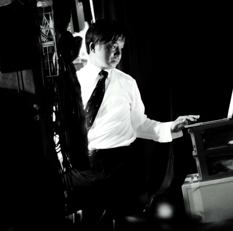 a man in a suit and tie is sitting at a desk