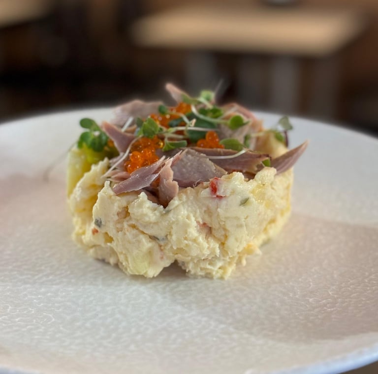 a person holding a plate with food on it