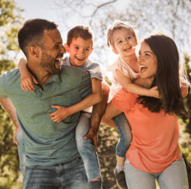 a family of four people are playing with a child