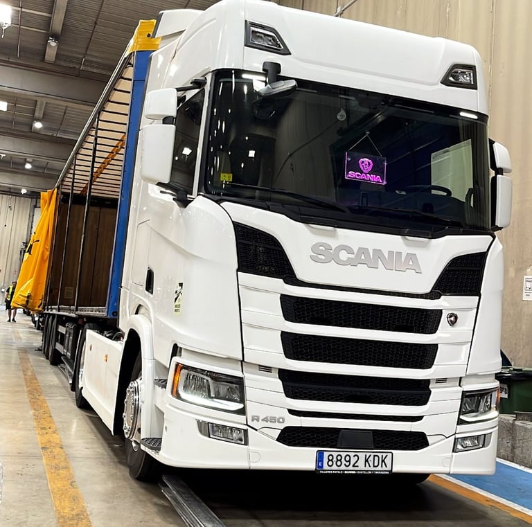a truck with a trailer parked in a warehouse