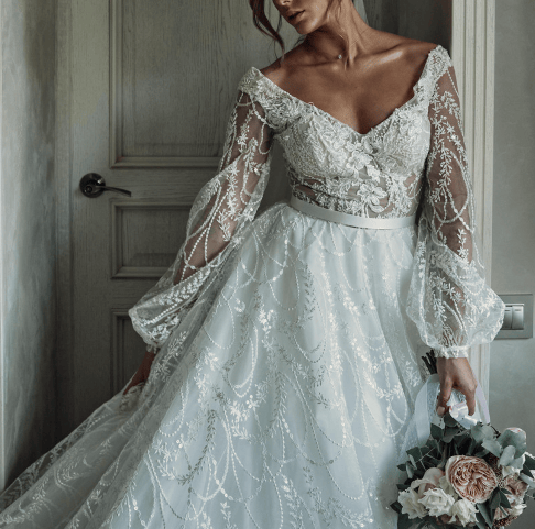 a woman in a wedding dress with a bouquet in her hand