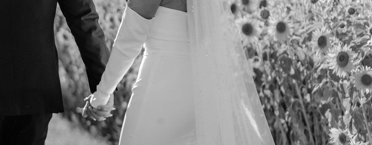 bride and groom in sunflower field