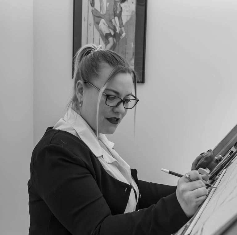 Creative portrait photoshoot with model at a drafting table in studio