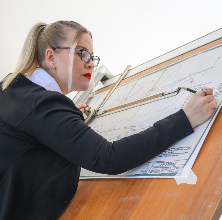 Model posing at a draftsman table during a studio photoshoot at Pretty in Pixels Rotherham
