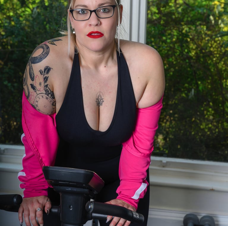 Model posing on an exercise bike during a studio photoshoot at Pretty in Pixels Rotherham