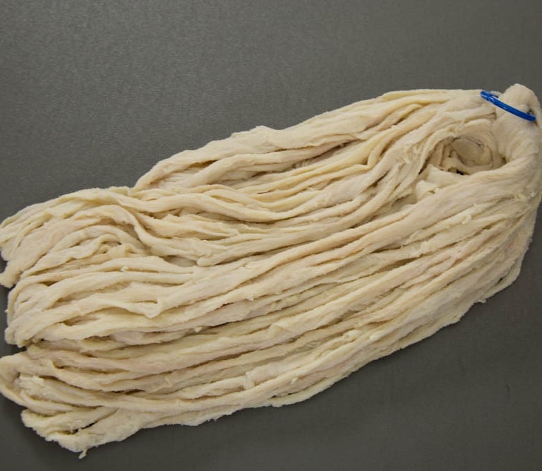 A bundle of natural Beef casings for sausage making, on a flat grey surface. at fivestarcasing.com