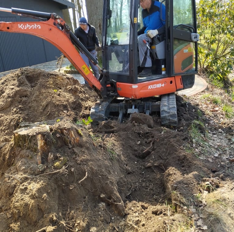 a man is standing in the dirt with a machine