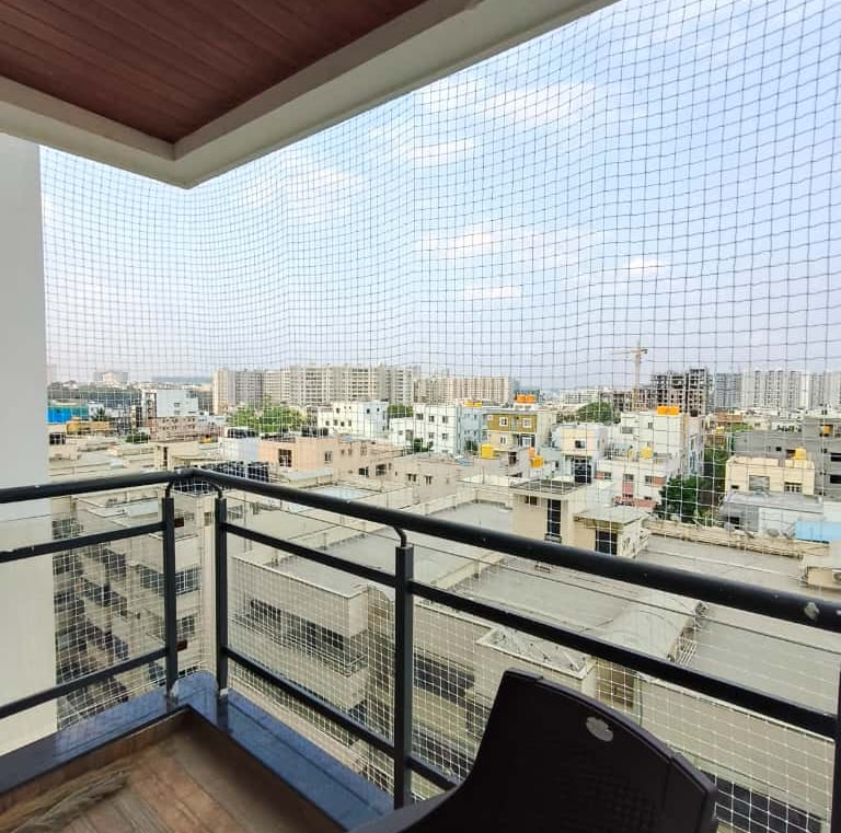 Safety net installation in progress on a residential balcony in Adyar.