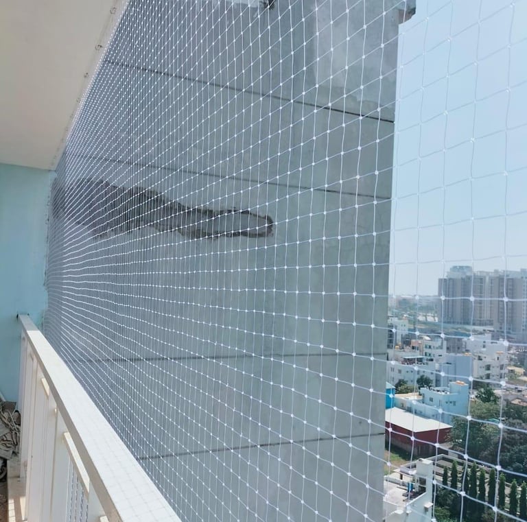 Pigeons perched nearby but unable to access the netted area.