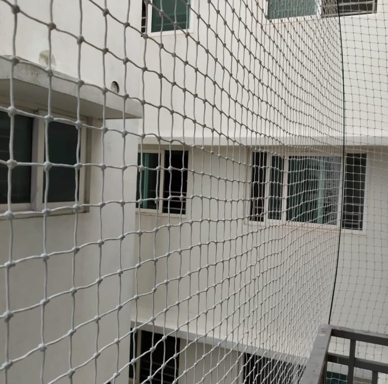 Close-up of a securely fitted balcony safety net in a modern Adyar apartment.