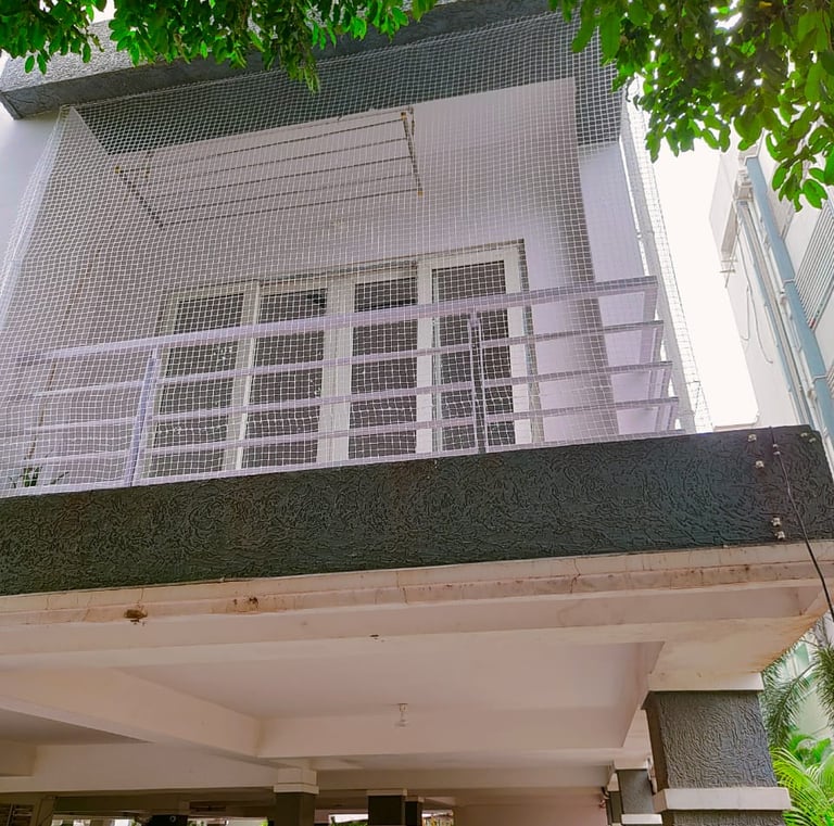 Detail of the netting material stretched across a rooftop edge.