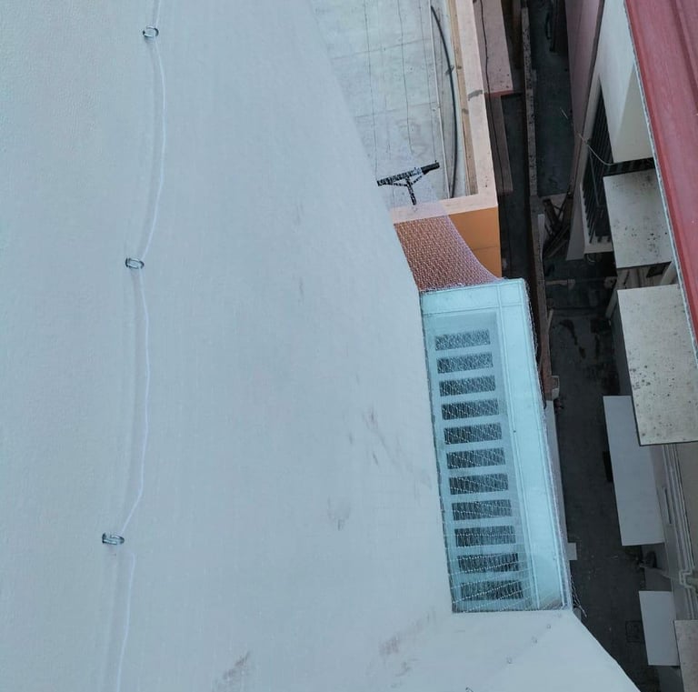 A clean, taut pigeon net stretched across a spacious balcony, blending seamlessly with the building’