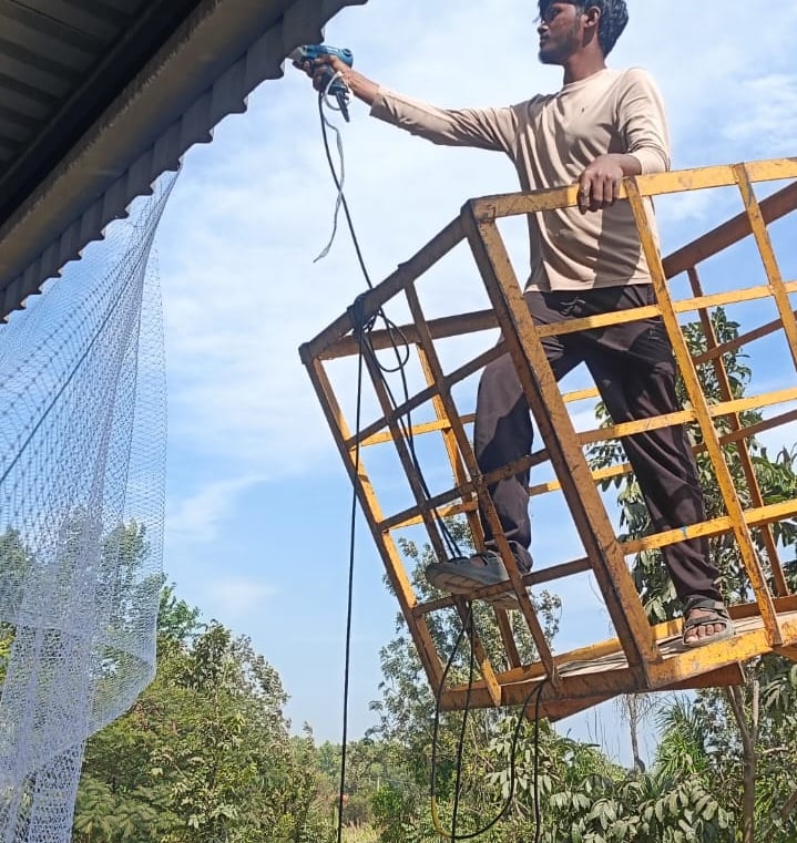 Interior view of a warehouse with pigeon nets preventing bird entry through ventilation openings.