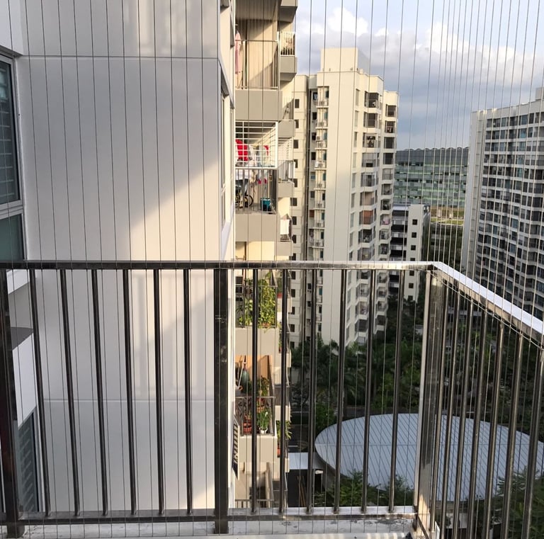 View of a child playing safely behind a newly installed balcony net.