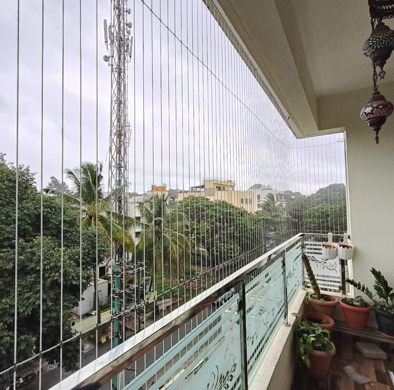Invisible grills blending into the frame of a large living room window egmore chennai