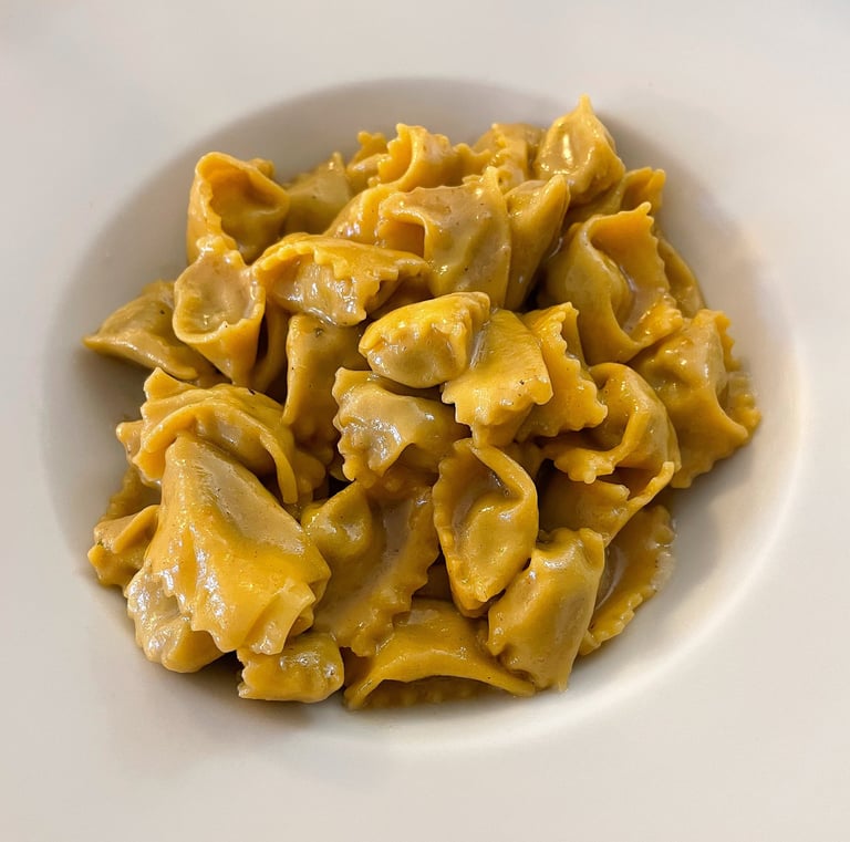 Plate of angolotti del plin in parmigiano fondue